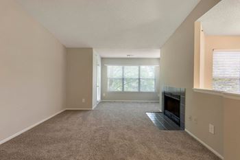 Carpeted Living Room with Fireplace and Large Windows